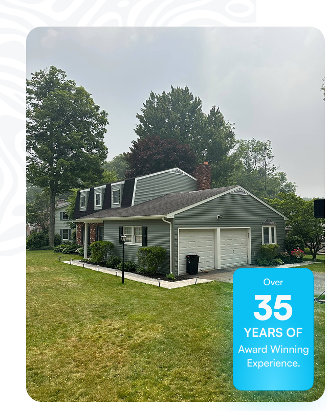 Residential home exterior with new roofing and well-maintained lawn