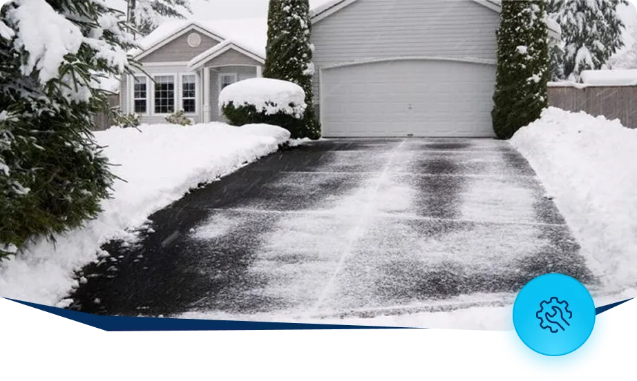 Snow cleared driveway in front of residential home after snow removal